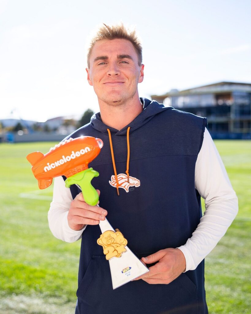 Denver Broncos QB Bo Nix holding 3D printed NFL Slimetime trophy